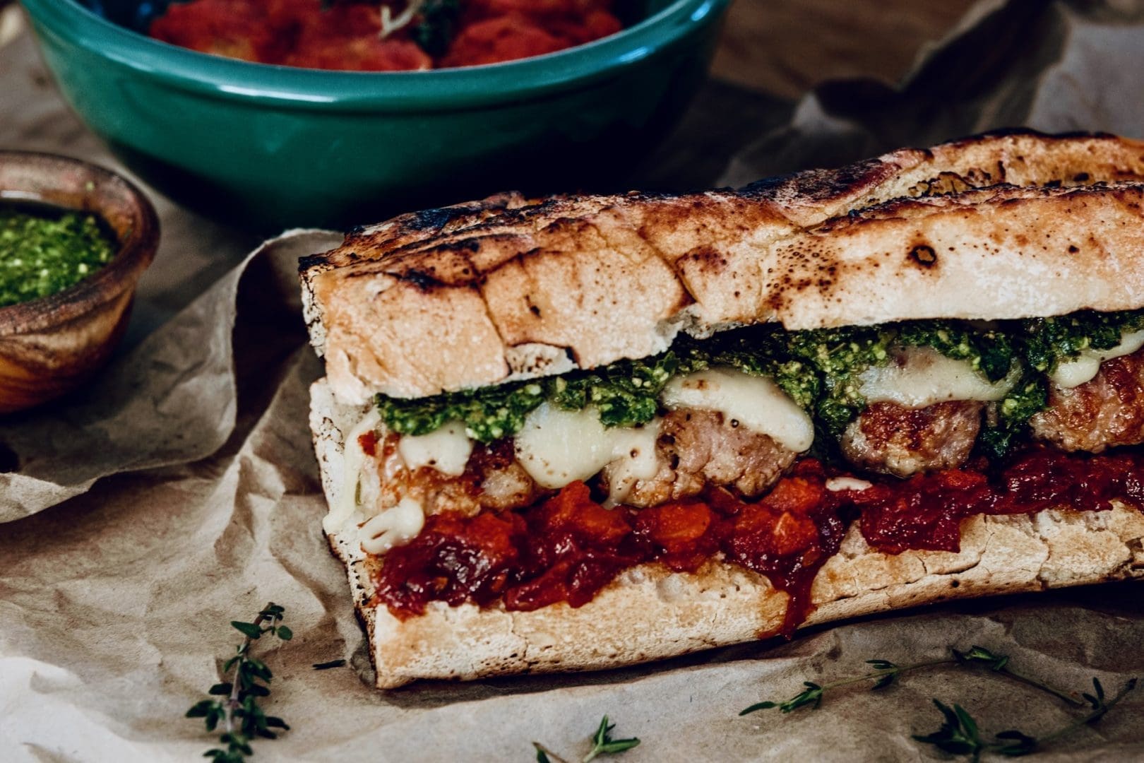 Pork meatball sub with homemade tomato relish and pesto